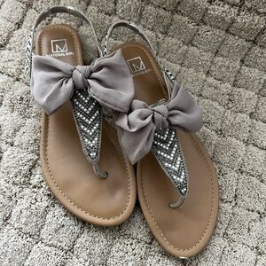 Material Girl Taupe Bow T-Strap Sandals with Rhinestone Accents